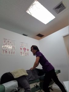 Dr. Natalie Meiri adjusts the spine and pelvis