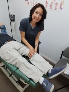 Dr. Natalie Meiri adjusts a patient's knee joint