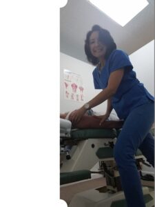 Dr. Natalie Meiri adjusts a patient's right shoulder